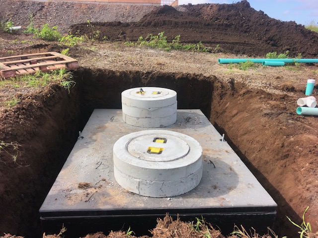 A concrete septic tank being installed on Maui