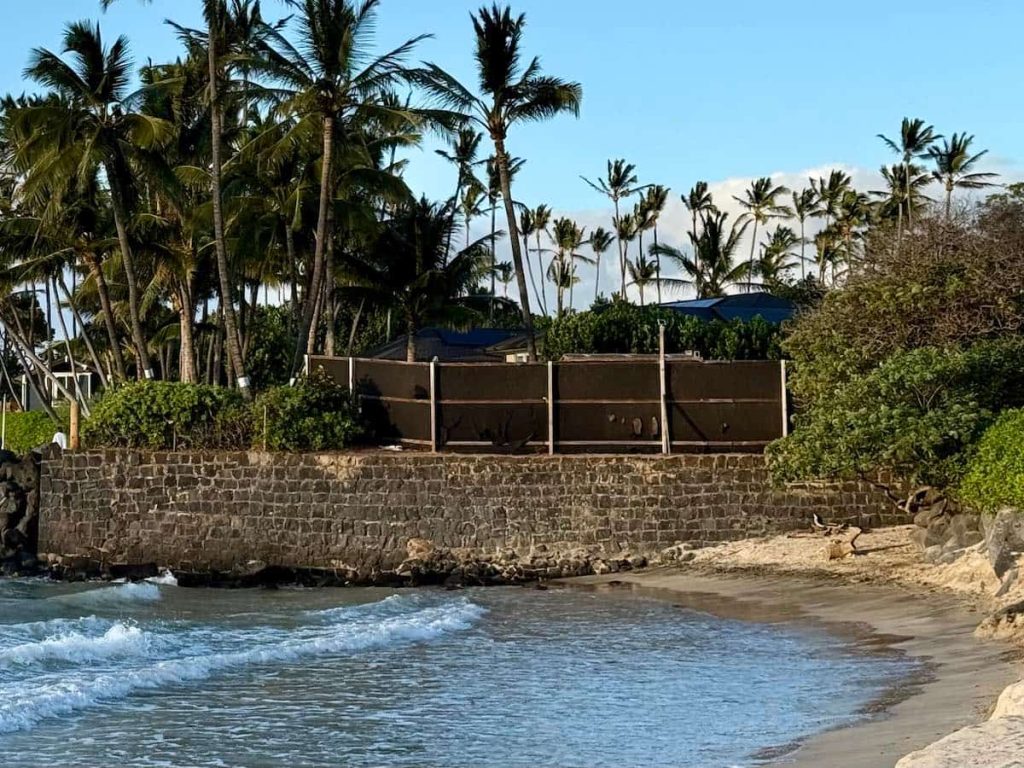 An old seawall protects the flank of a Maui oceanfront home