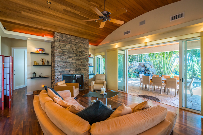 Barrel ceilings and a stone fireplace in the living room of 193 Ohaoha. 
